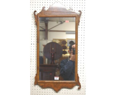 A Chippendale style figured walnut fret carved wall mirror
