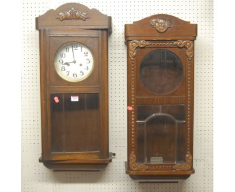 A 1930s oak drop trunk wall clock (lacking accessories), together with a walnut drop trunk clock case from the same period (2