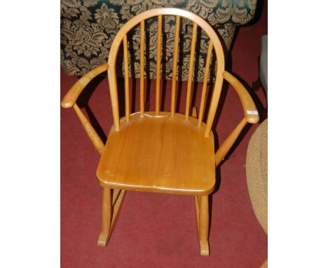 An Ercol light elm stickback open rocking elbow chair