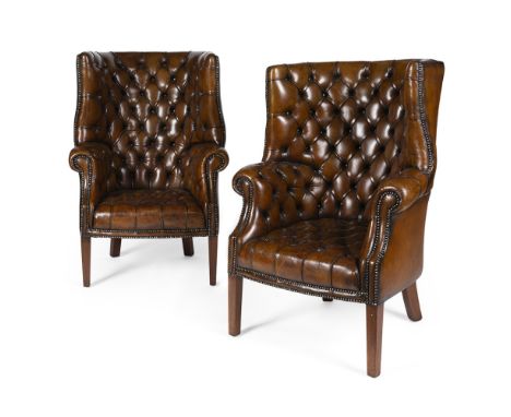PAIR OF GEORGIAN STYLE BARREL-BACK LEATHER ARMCHAIRS20TH CENTURY the button-upholstered backs and scroll arms above loose cus