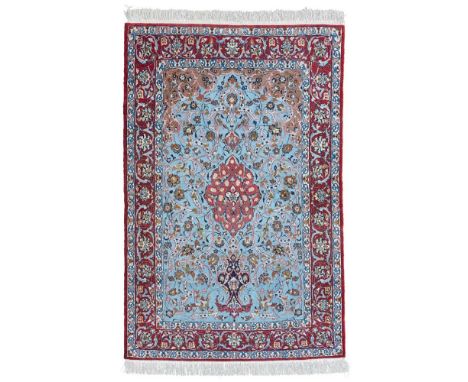 ISFAHAN PART SILK PRAYER RUGCENTRAL PERSIA, LATE 20TH CENTURY the light blue mihrab with red medallion, brown spandrels, with