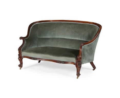 VICTORIAN WALNUT FRAMED SOFA19TH CENTURY the curved back and scrolled arms upholstered in green plush, raised on floral scrol