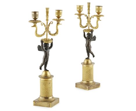 PAIR OF FRENCH EMPIRE GILT AND PATINATED BRONZE CANDELABRAEARLY 19TH CENTURY modelled as putti holding twin candle sconces, r