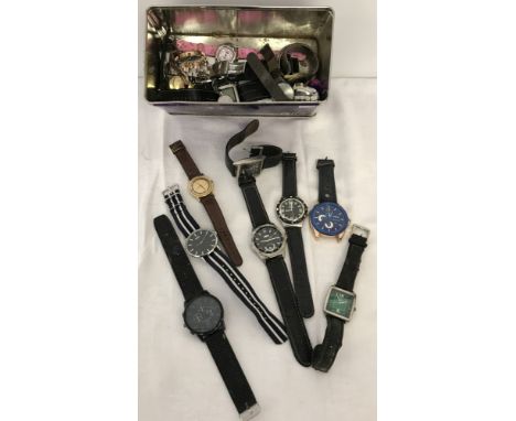 A tin of assorted men's, women's and children's wristwatches in varying conditions. To include Slazenger, Ferex, Casio and Ti