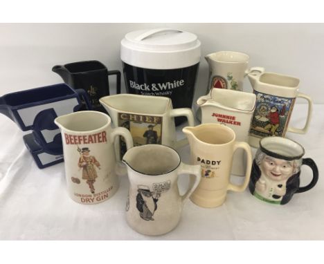 A vintage black and white plastic lidded ice bucket. Together with 10 ceramic water jugs to include Wade and Royal Doulton, i