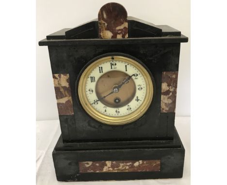 A vintage black slate and marble mantle clock. With key and pendulum, in working order. Approx. 29.5cm tall x 22.5cm wide.