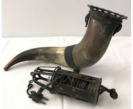 A vintage cornucopia made from a cattle horn together with a vintage cycle lamp.  