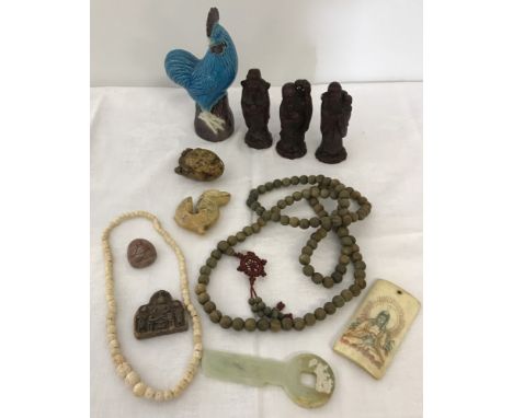 A collection of oriental items. To include amulets, prayer beads, jade decorative key and carved figures of 3 gods. 