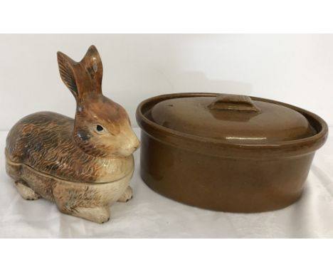 A vintage French ceramic pate container in the shape of a rabbit. Together with a large brown glazed casserole dish with lid.