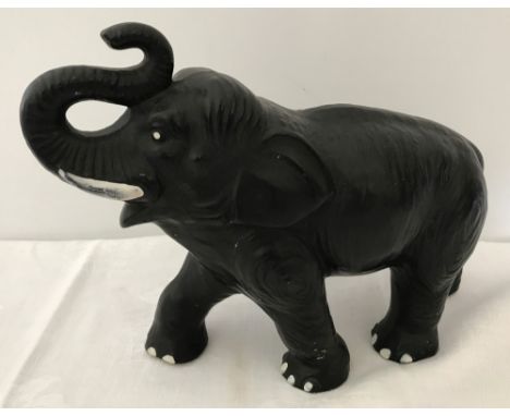 A c1950's ceramic elephant. Painted black. Marked 'Made in England 770'. Possibly Sylvac or Sylvac type. 24cm long.