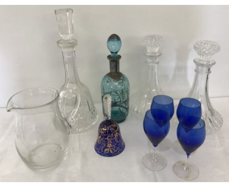 A quantity of assorted clear and coloured glassware items. To include a pair of matching ships decanters, clear glass jug and