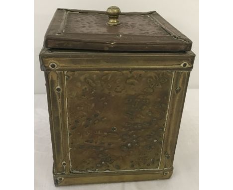 An Arts & Crafts square shaped metal covered wooden tea caddy.  