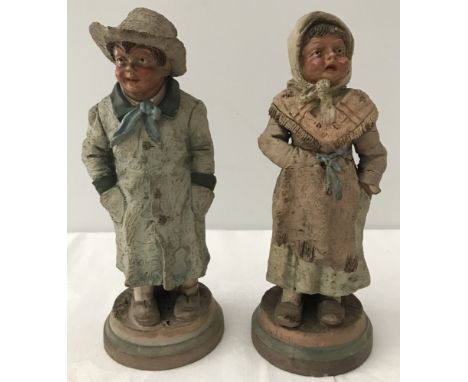 A pair of Dutch ceramic boy and girl figurines. Marks to base of boy 290 54, marks to base of girl 291 54. Both a/f. 