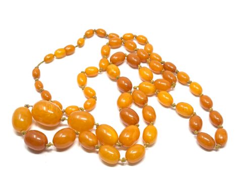 Vintage long egg yolk amber bead necklace measures approx  115 cm long weight approx 52g 