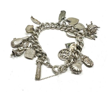 A vintage silver charm bracelet with assorted novelty charms (84g) 