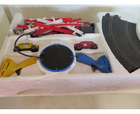 A Scalextric set with two Mini Coopers, track and controllers