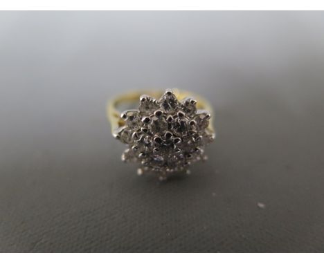 An 18ct yellow gold and diamond cluster ring size H - approx weight 4 grams - clean and bright
