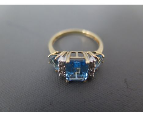 A 10ct yellow gold light blue stone and diamond chip ring size N - approx weight 2.8 grams - minor usage wear