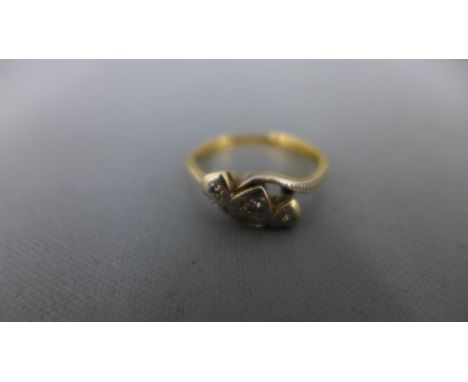 An 18ct yellow gold and three stone diamond ring - approx 2.2 grams - ring size K - usage wear