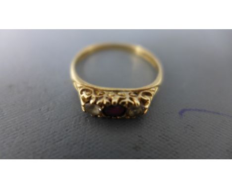 A 9ct yellow gold diamond and ruby ring - weight approx 2 grams - some usage wear