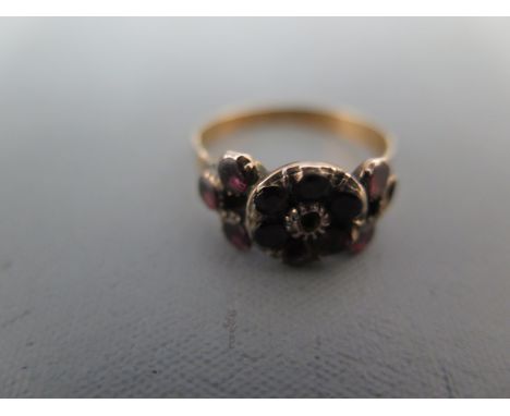 A 9ct gold and garnet ring size O/P - approx weight 2.5 grams - one stone missing