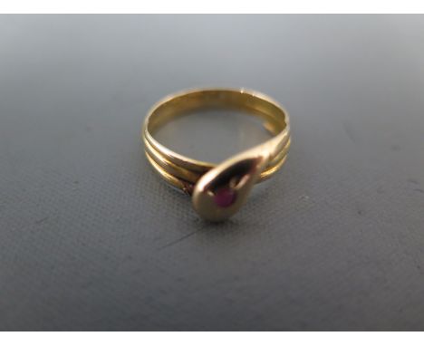 A 15ct yellow gold ring in the form of a snake with ruby eye - ring size M - approx weight 2.5 grams - clean and bright