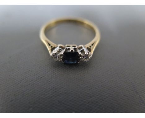 A sapphire and diamond ring in 9ct yellow gold setting - approx weight 2.6 grams - ring size O - clean and bright