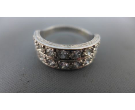 A platinum and diamond ring - total diamond weight approx 1ct made up of 18 0.06ct diamonds - weight approx 8.8 grams - ring 