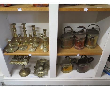 A collection of copper and brass ware to include trivet desk stand, watering cans and candlestick - 17 pieces in total