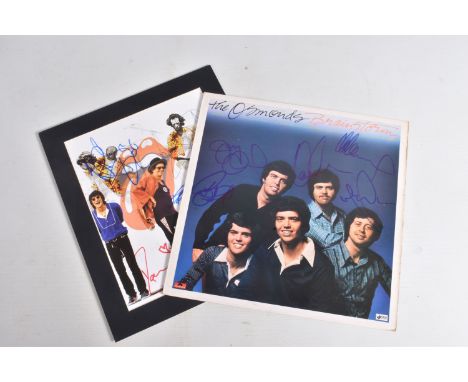 TWO SIGNED PHOTOGRAPHS, one is of the Rolling Stones signed in various colour ink by each band member and a signed Osmond Bro