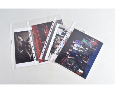 FOUR SIGNED 10   X 8   PHOTOGRAPHS OF THE ROLLING STONES BAND, each photograph is in colour and signed with a marker, each ph