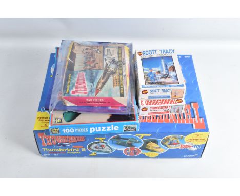A COLLECTION OF ASSORTED THUNDERBIRD COLLECTIBLES, to include a hardback book 'Thunderbirds International Rescue Annual', a T
