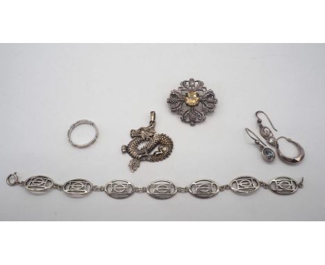 Mixed lot of 925 silver,
silver thistle brooch,
Rennie MackIntosh design bracelet,
3x odd earrings,
dragon pendant&nbsp;
ring