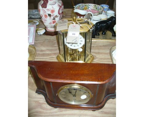 A Kundo reproduction torsion clock within a hexagonal glass case and an early 20th century mahogany cased mantel clock with a