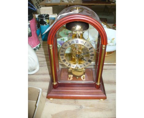 A Hermle, striking mantel clock.  With an 11cm dial with Roman numerals, blued hands, the single-train movement striking on a