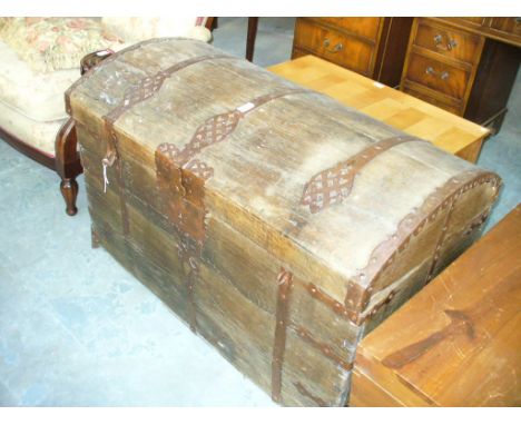 A 17th Century iron bound oak domed trunk
Flanked by twin carrying handles, some restoration and further damage throughout, w