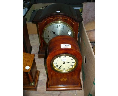 An Edwardian inlaid domed mahogany mantel clock and a second presentation mantel clock with a silvered dial. (2)