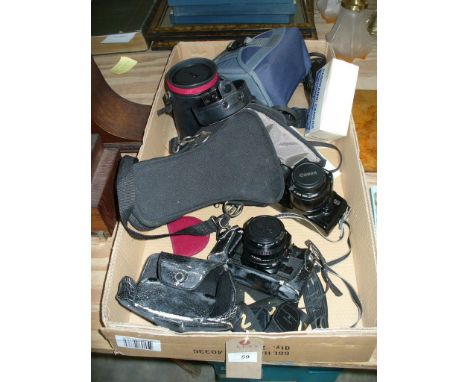 A Canon A1 camera, a Canon EOS 500 camera, a cased Sigma lens and other cameras.