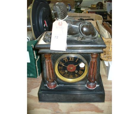A Victorian Egyptian revival slate mantel clock with a bronzed sphinx above a painted dial flanked by half columns.