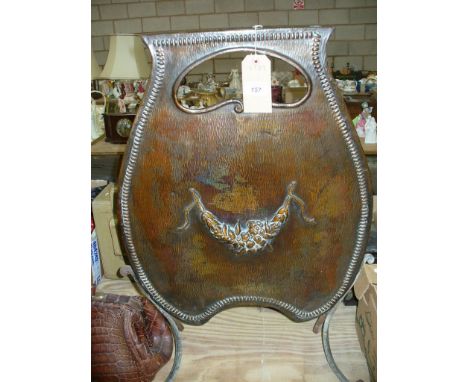 A 19th Century copper oxidised shield shaped fire screen with a kidney shaped aperture.