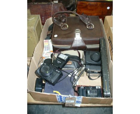A Qty of camera and accessories including a cased Canon camera and lens.