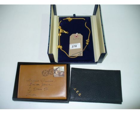An  Alfred Dunhill  leather wallet, a second wallet and a boxed Beaverbrooks gold coloured chain with pendants.