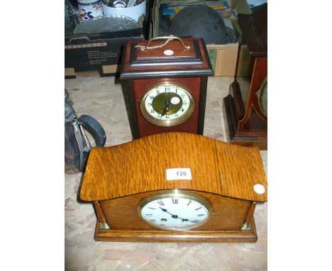 An Early 20th century oak cased mantel clock with a white enamel dial  and a second mantel clock with a gilt metal and enamel