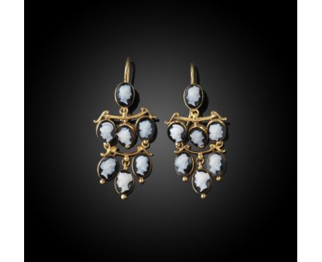 A pair of cameo chandelier earrings, each set with seven hardstone cameos in gold rubover settings, the cameos depicting the 