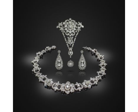 An important diamond parure, mid 19th century, comprising: a devant de corsage brooch, centring on a ten-petalled flower with