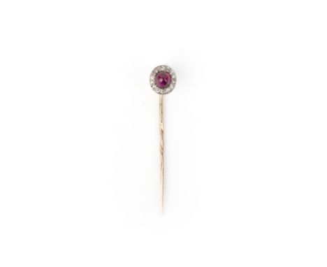 A ruby and diamond stick pin, early 20th century, set with a cabochon ruby within a millegrain-bordered surround of circular-