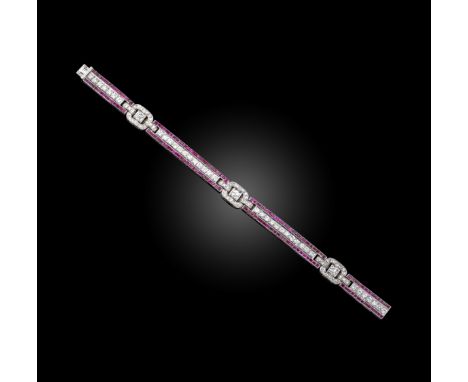 A ruby and diamond bracelet, set with a central line of circular-cut rubies within a border of calibre-cut rubies separated w