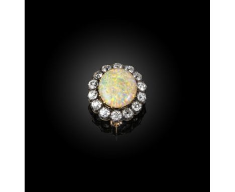 A late 19th century opal and diamond cluster brooch, set with an oval opal cabochon within diamond border in silver and gold,