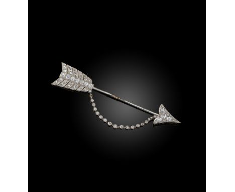 An early 20th century diamond jabot pin, designed as a stylised arrow joined with an articulated line of diamonds in platinum