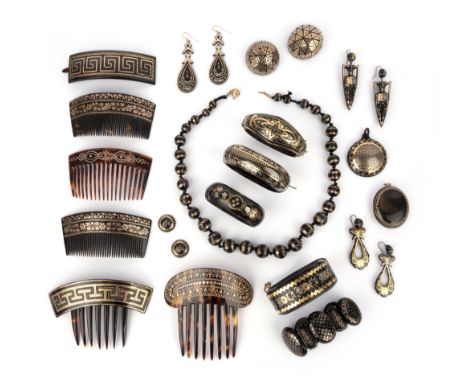 λ A collection of tortoiseshell piqué-work jewels, 19th century, comprising: five haircombs; a pair of pendent earrings of am